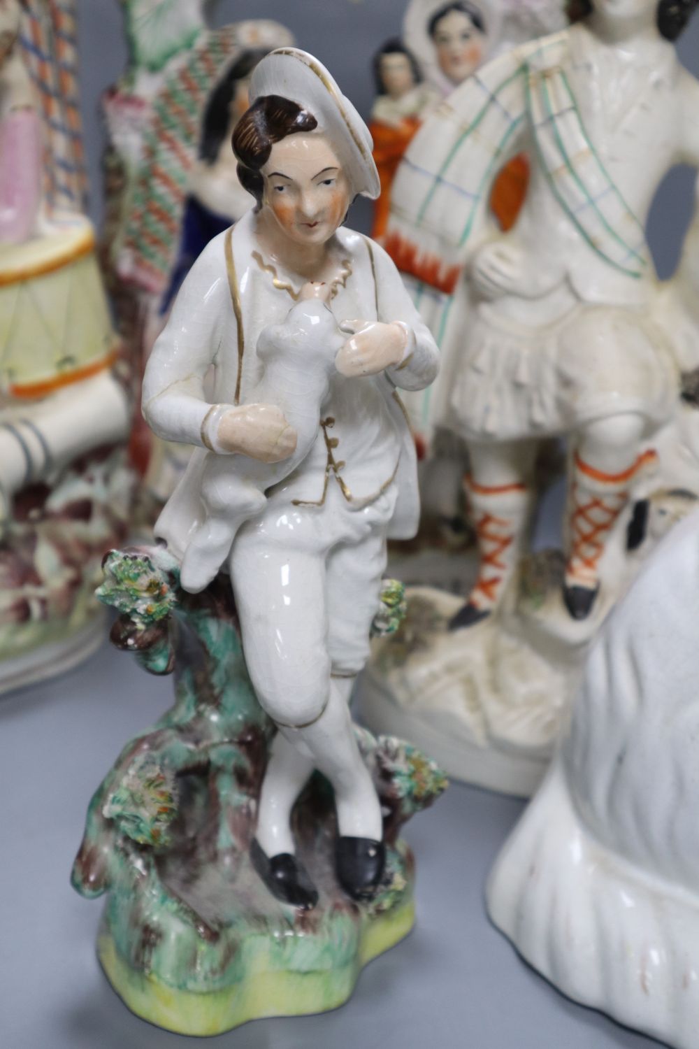 A collection of Staffordshire figures, including a flatback entitled Fortune Teller, height 32cm,